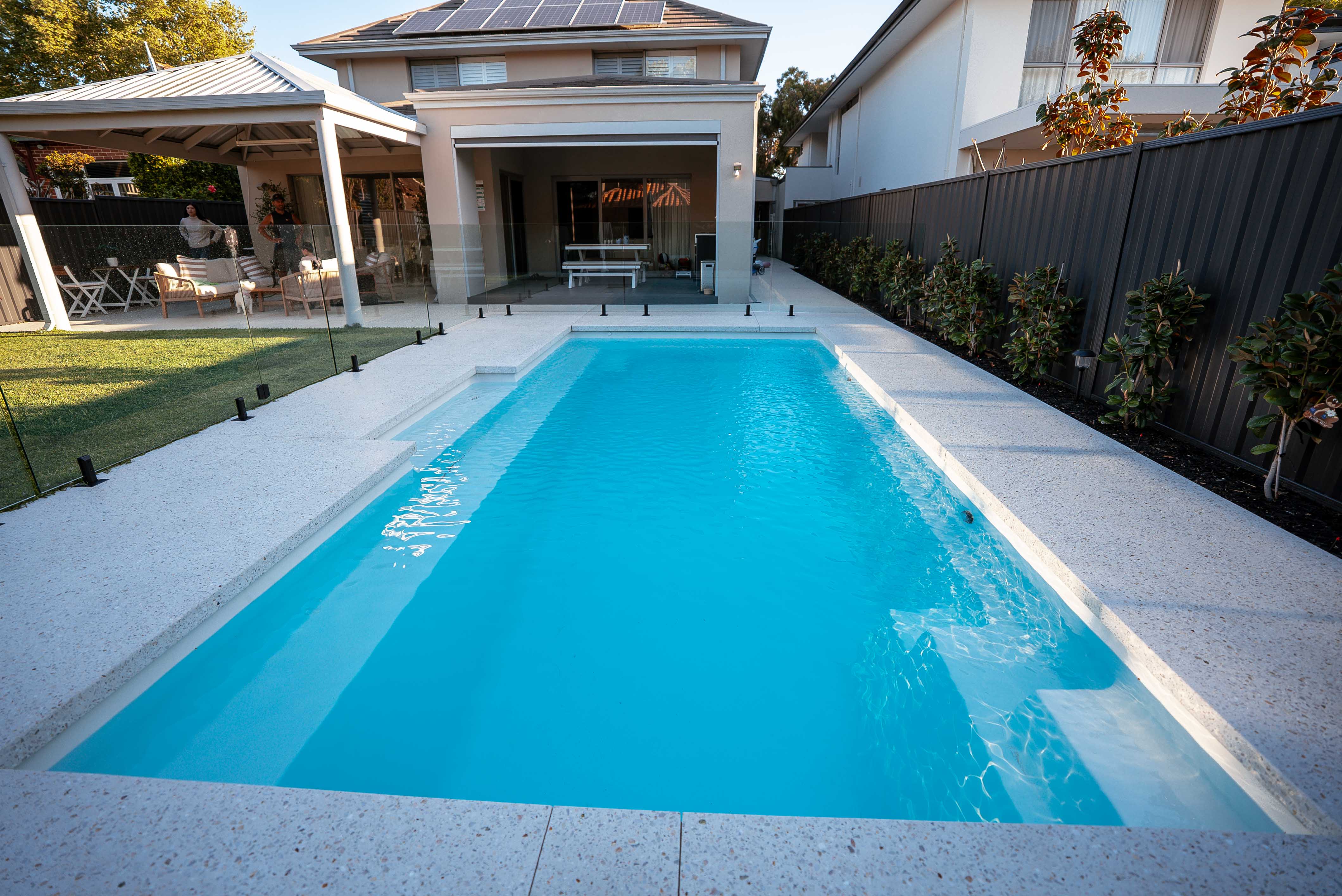 Pool with landscaped surrounds and paving