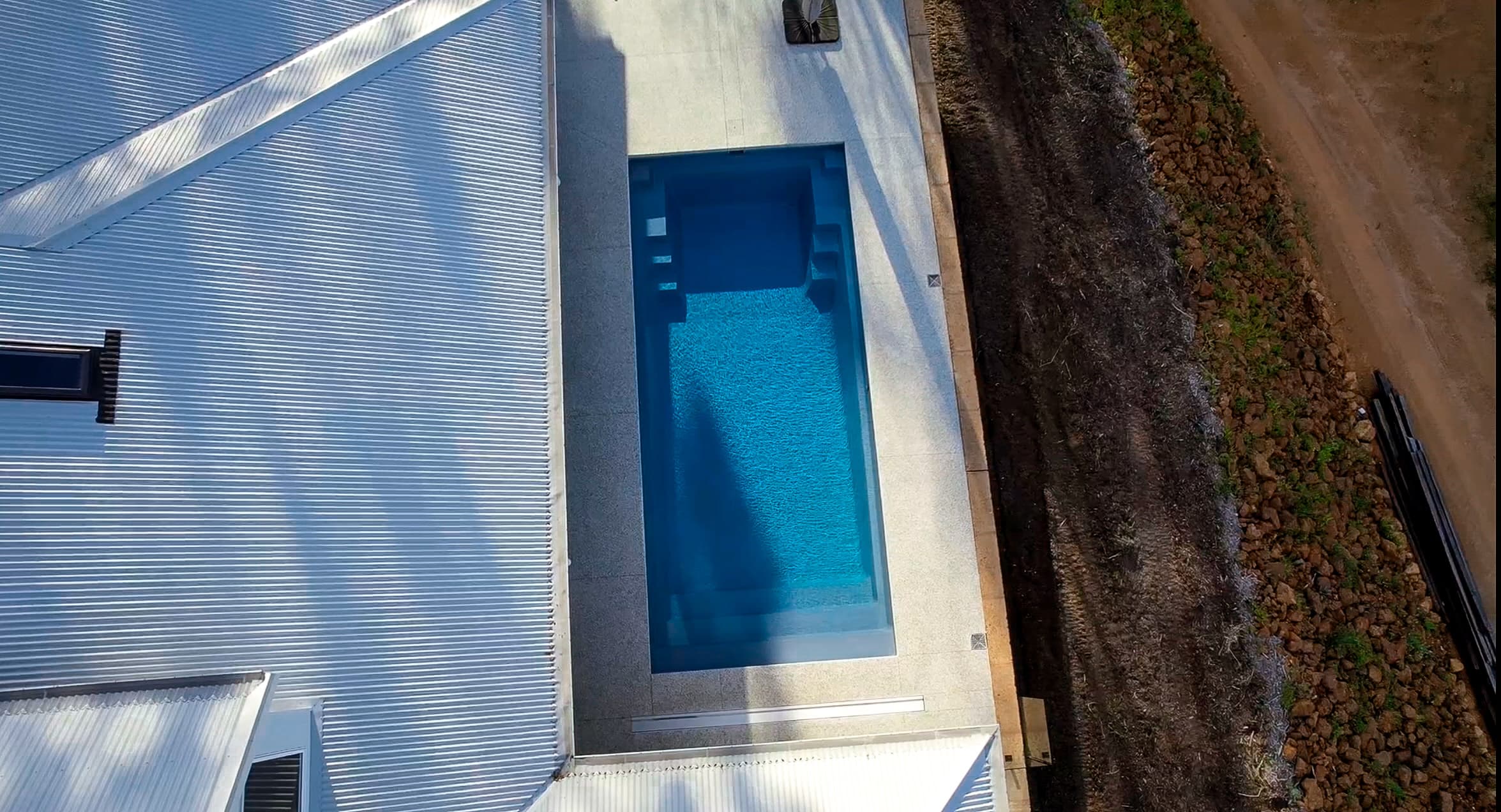 Pool and garden composition from side angle